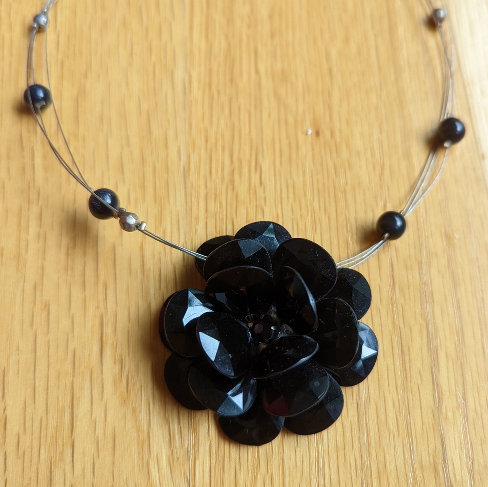 Black plastic flower necklace